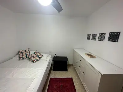 a white bedroom with a bed and a desk at Vallromanes House of Peace and Rest in Vallromanas