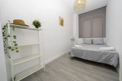 a bedroom with a bed and a book shelf at HomeHolidaysRentals Balmes - Costa Barcelona in Calella