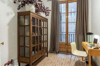 a living room with a couch and a fireplace at Canela Homes MIDTERM ELEGANCE in Barcelona
