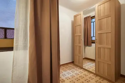 a hallway with two wooden doors and a mirror at BBarcelona Perill Flat in Barcelona