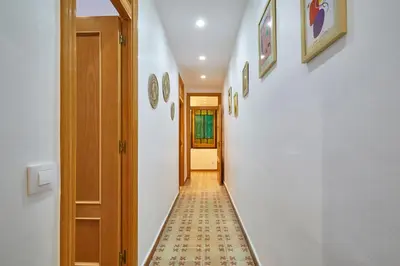 a hallway with a tile floor and an open door at BBarcelona Perill Flat in Barcelona