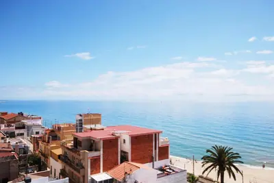 a view of the beach from a building at Waves and sky in Montgat