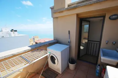 a bathroom with a sink and a toilet and a mirror at Waves and sky in Montgat