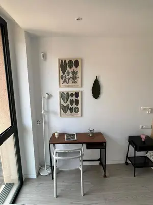 a desk in a room with a chair and paintings at Artistic beach apartment in Cunit