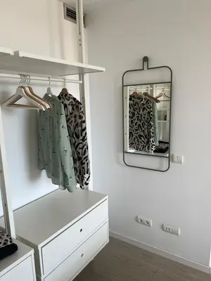 a dressing room with a mirror and a dresser at Artistic beach apartment in Cunit
