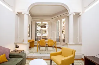 a living room with a table and chairs at Elegant and cozy retreat in Barcelona