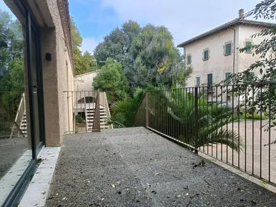 an entrance to a building with a metal gate at El Freixe de l'Ylla in Els Hostalets