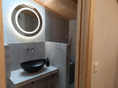 a bathroom with a black sink and a mirror at El Freixe de l'Ylla in Els Hostalets