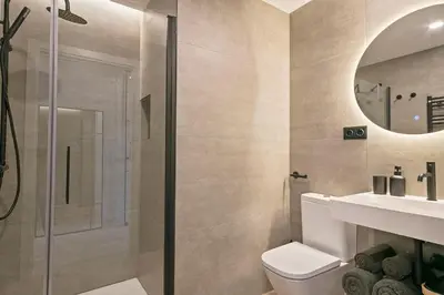 a bathroom with a shower and a toilet and a sink at Joan Austria 2 Bedroom Apartment in Barcelona