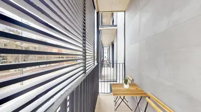 a hallway with blue and white stripes on the wall at Joan Austria 2 Bedroom Apartment in Barcelona