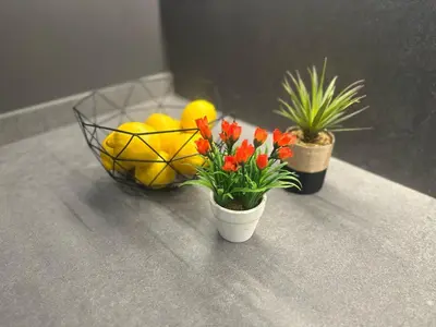 a bowl of lemons and flowers on a counter at Joan Austria 2 Bedroom Apartment in Barcelona