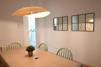 a dining room table with chairs and a lamp at Homenfun Barcelona Avenida Diagonal in Barcelona
