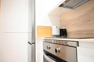 a kitchen with a stove top oven next to a door at Homenfun Barcelona Avenida Diagonal in Barcelona