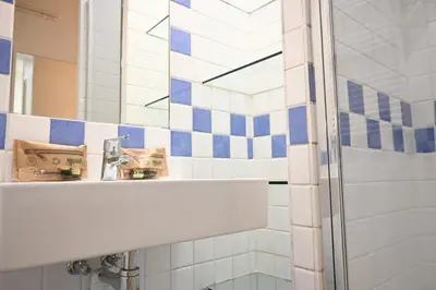 a bathroom with a sink and a mirror at Homenfun Barcelona Avenida Diagonal in Barcelona