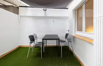 a table and chairs in a room with green carpet at Stay U-nique Apartments Villarroel II in Barcelona