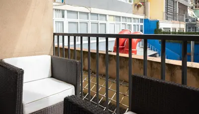 a balcony with a chair and a pool at Stay U-nique Apartments Villarroel II in Barcelona