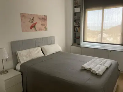 a bedroom with a bed with two towels on it at Apartamento con vistas al mar in Castelldefels