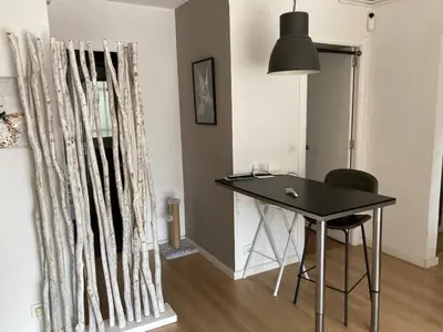 a black table and chairs in a room at Apartamento con vistas al mar in Castelldefels