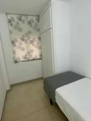 a bedroom with a bed and a painting on the wall at Apartament a Arenys de Mar in Arenys de Mar