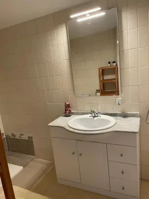 a bathroom with a sink and a mirror at Apartament a Arenys de Mar in Arenys de Mar