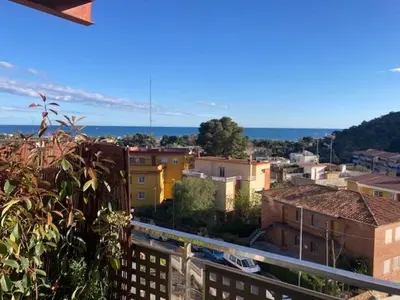 a view of a city from a balcony at Apartamento con vistas al mar in Castelldefels