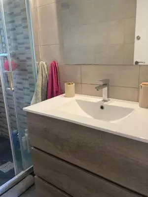 a bathroom with a sink and a shower at Apartamento con vistas al mar in Castelldefels