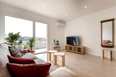 a living room with a couch and a tv at Apartamento artístico Vilanova in Vilanova i la Geltrú