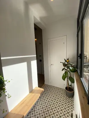 a hallway with a potted plant and a door at Poble Sec Charming Apartment in Barcelona