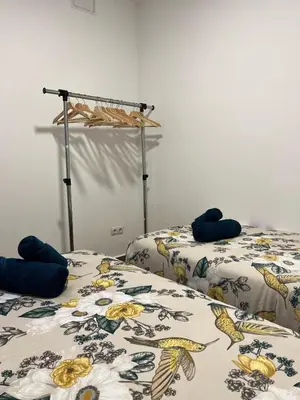 two beds sitting next to each other in a room at Modern apartment Barcelona in Badalona