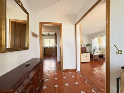 a living room with a tile floor and a mirror at Charming Catalan Villa with Pool & Views in Cunit