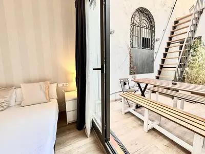 a room with a bed and a bench on a balcony at Piso con dos habitaciones con camas dobles y terrazas en el Poblenou in Barcelona