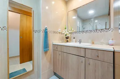 a bathroom with a sink and a mirror at Hauzify I Casa Ribera in Cunit