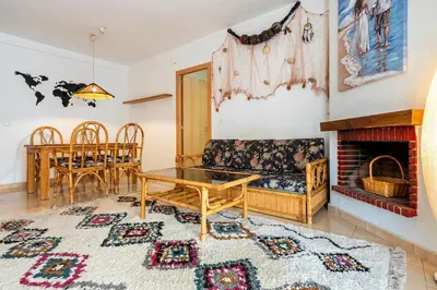 a living room with a couch and a fireplace at Hauzify I Casa Ribera in Cunit