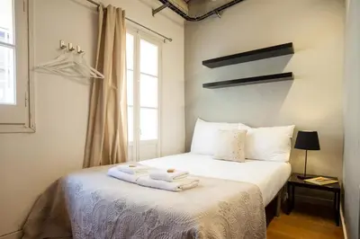 a bedroom with a bed with towels on it at Click&Flat Gothic apartments in Barcelona