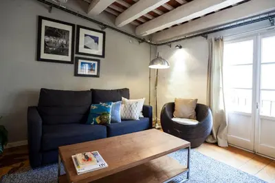 a living room with a blue couch and a coffee table at Click&Flat Gothic apartments in Barcelona