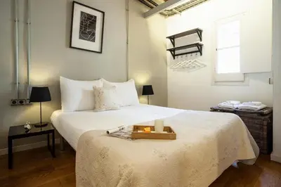 a bedroom with a large bed with a tray on it at Click&Flat Gothic apartments in Barcelona