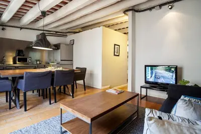 a living room with a table and a dining room at Click&Flat Gothic apartments in Barcelona