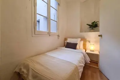 a small bedroom with a bed and a window at 21ARA1085- Fabulous 4BR apartment in Ciutat Vella in Barcelona