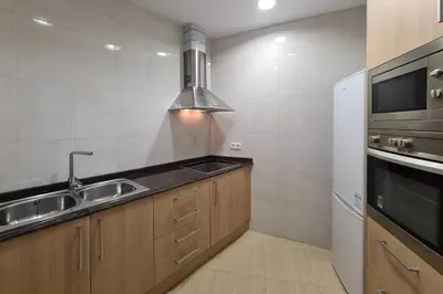 a small kitchen with a sink and a microwave at 21ARA1085- Fabulous 4BR apartment in Ciutat Vella in Barcelona
