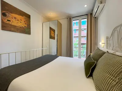a bedroom with a white bed and a window at Stay Unique Apartments Mallorca III in Barcelona