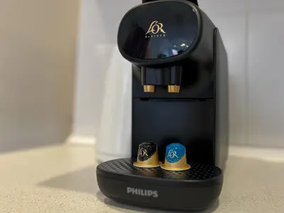 a coffee maker with two tiny shoes on it at Stay Unique Apartments Mallorca III in Barcelona