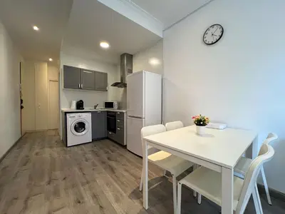 a kitchen and dining room with a table and a refrigerator at Stay Unique Apartments Mallorca III in Barcelona