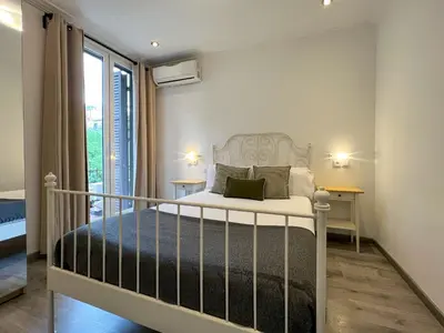 a bedroom with a bed and a large window at Stay Unique Apartments Mallorca III in Barcelona
