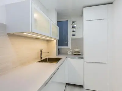 a kitchen with white cabinets and a sink at Nice, Cozy, UP TO 6, FCB stadium, free parking in Barcelona