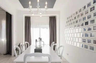 a white dining room with a white table and chairs at Nice, Cozy, UP TO 6, FCB stadium, free parking in Barcelona