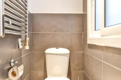 a bathroom with a toilet and a window at Montroig Mar in Sitges
