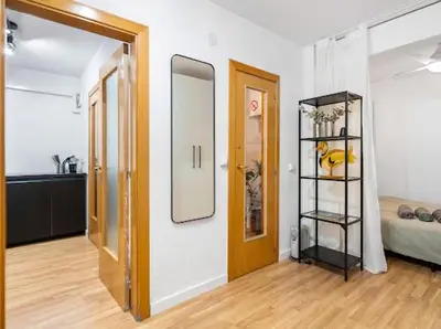 a room with a hallway with a mirror and a bedroom at Apartments near the airport in Cornellà de Llobregat