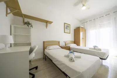 a hospital room with two beds and a desk at HomeHolidaysRentals Olai - Costa Barcelona in Pineda de Mar