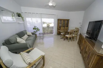 a living room with a couch and a flat screen tv at HomeHolidaysRentals Olai - Costa Barcelona in Pineda de Mar
