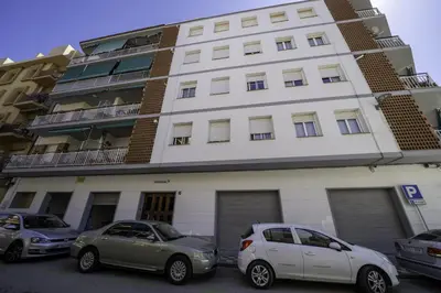 two cars parked in front of a building at HomeHolidaysRentals Olai - Costa Barcelona in Pineda de Mar